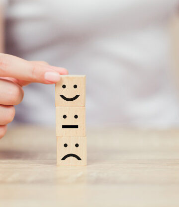 customer-pressing-smiley-face-emoticon-wood-cube_34936-2180